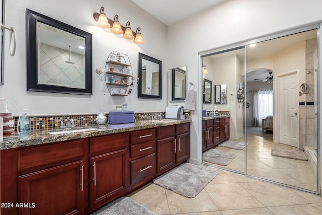 bathroom featuring decorative backsplash, vanity, walk in shower, ceiling fan, and tile patterned floors