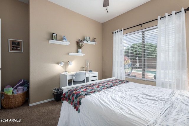 bedroom featuring ceiling fan and carpet