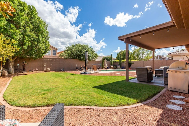 view of yard with a fenced in pool and a patio area