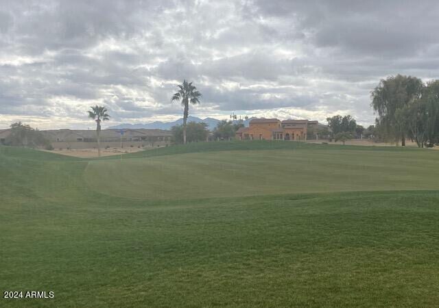 view of community featuring a lawn and a mountain view