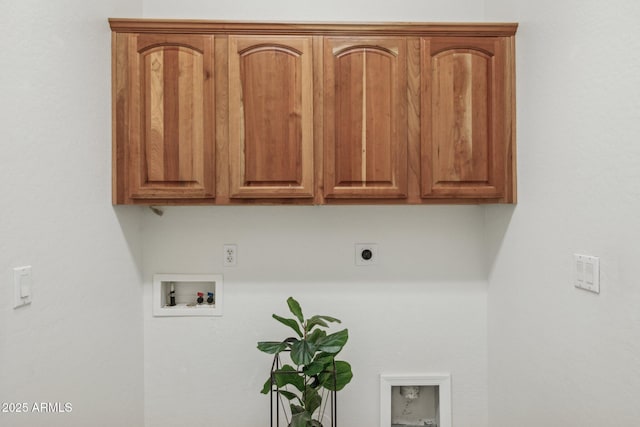 washroom with electric dryer hookup, cabinet space, and hookup for a washing machine