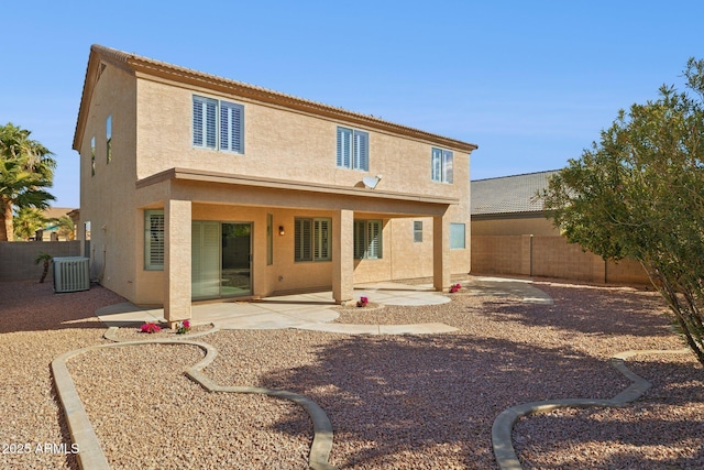 back of property featuring a patio area, central air condition unit, stucco siding, and a fenced backyard