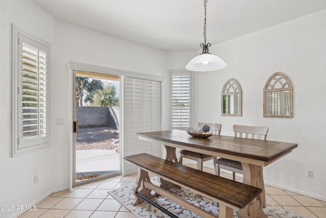 dining room featuring light tile patterned flooring and baseboards