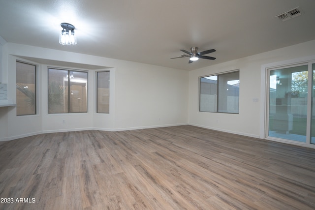 spare room with ceiling fan and hardwood / wood-style flooring