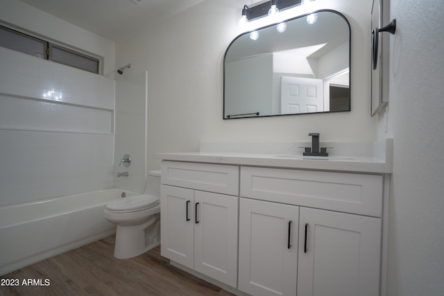 full bathroom with vanity, hardwood / wood-style flooring, bathing tub / shower combination, and toilet