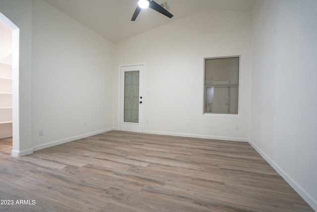 unfurnished room featuring ceiling fan, light wood-type flooring, and high vaulted ceiling