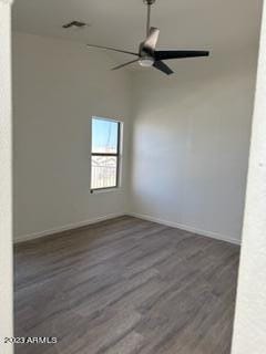 spare room featuring dark hardwood / wood-style floors and ceiling fan