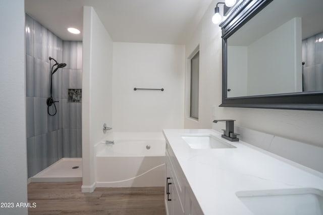 bathroom featuring vanity, separate shower and tub, and hardwood / wood-style floors