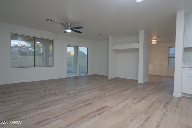 unfurnished living room with ceiling fan and light hardwood / wood-style flooring