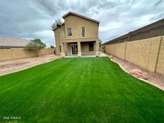 rear view of house with a yard