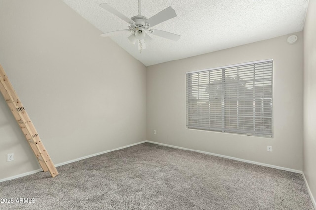 unfurnished room with vaulted ceiling, ceiling fan, carpet floors, and a textured ceiling