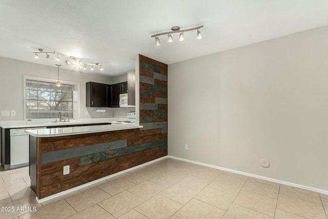 kitchen with kitchen peninsula, stove, dishwashing machine, sink, and hanging light fixtures