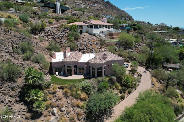 birds eye view of property with a mountain view