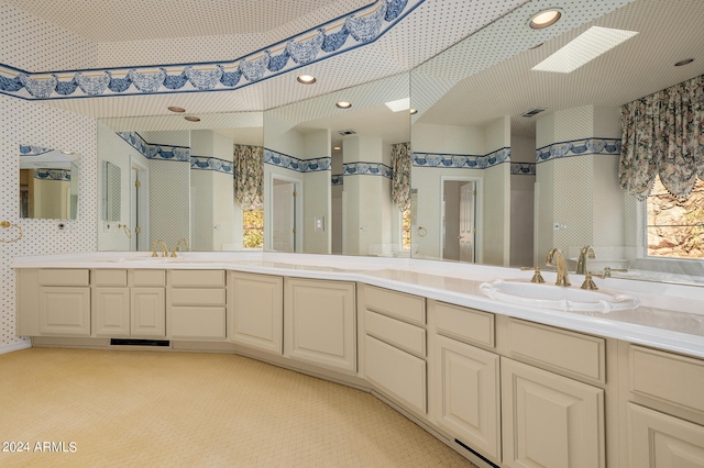 bathroom featuring vanity and a skylight