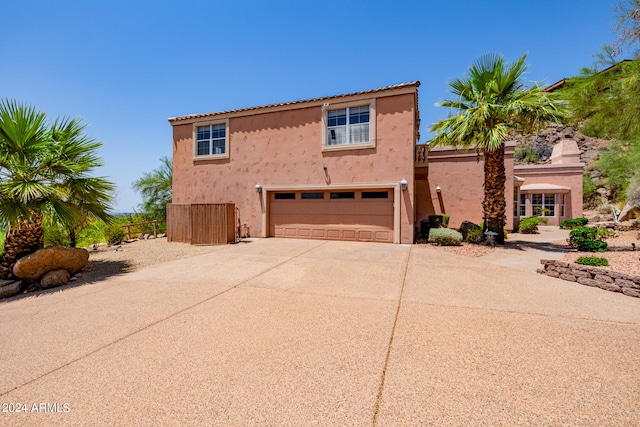 mediterranean / spanish home featuring a garage