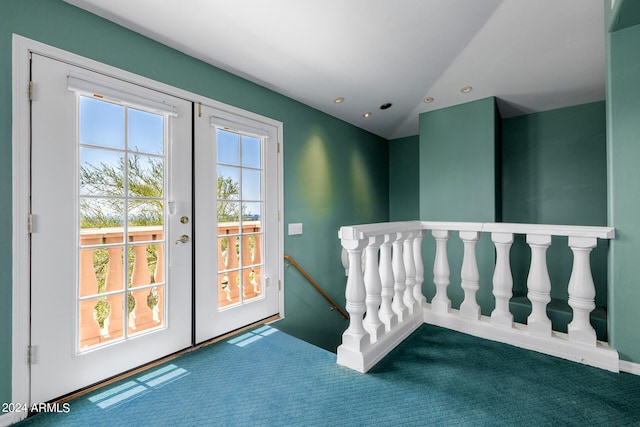 carpeted spare room featuring french doors