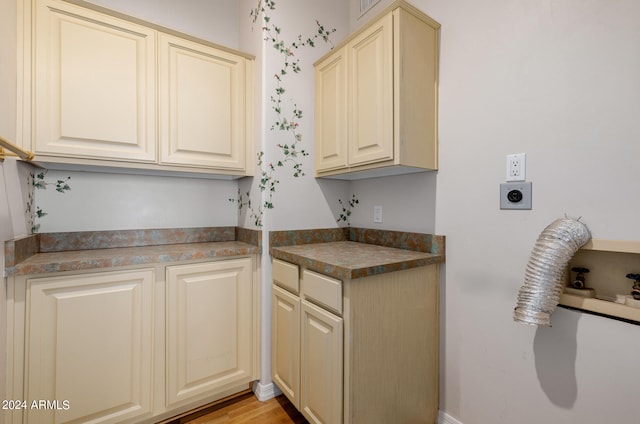 kitchen with cream cabinets and light hardwood / wood-style floors