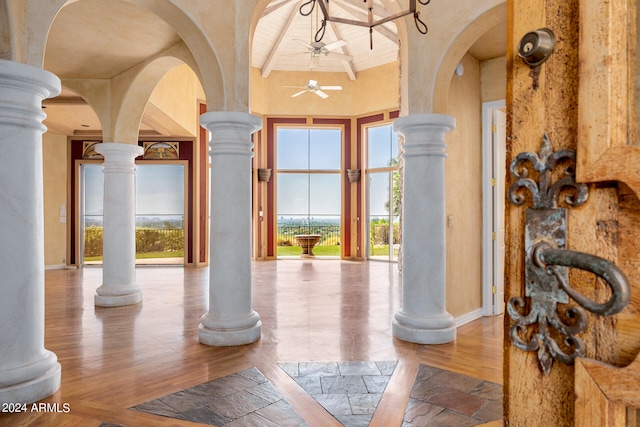 interior space featuring decorative columns and ceiling fan