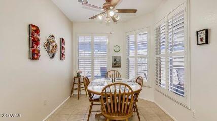 tiled dining space featuring ceiling fan