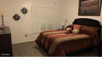 bedroom with dark colored carpet