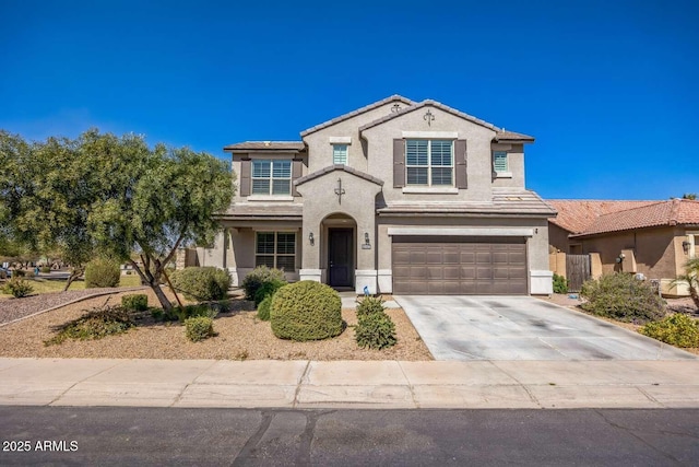 view of front facade featuring driveway, an attached garage, a tiled roof, and stucco siding