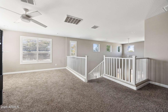 spare room with a healthy amount of sunlight, baseboards, and visible vents