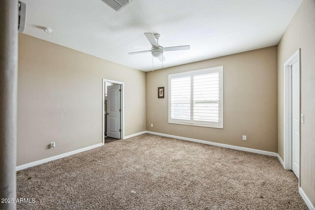 unfurnished bedroom featuring carpet flooring, visible vents, and baseboards