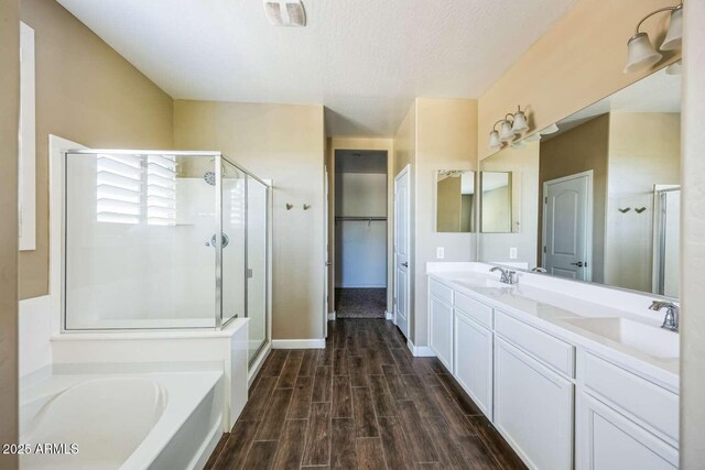 full bath with a shower stall, wood tiled floor, visible vents, and a sink