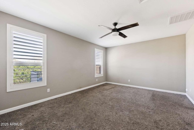 carpeted spare room featuring visible vents, ceiling fan, and baseboards