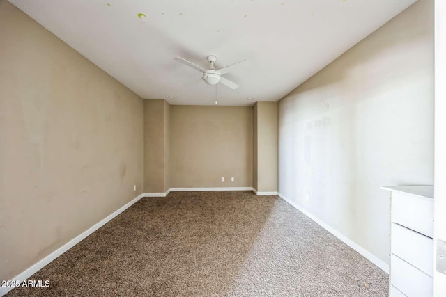 unfurnished room featuring carpet floors, baseboards, and a ceiling fan