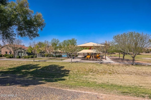 surrounding community featuring playground community and a lawn