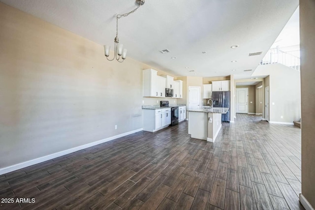 kitchen featuring stainless steel appliances, open floor plan, visible vents, and dark wood-style floors