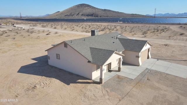 birds eye view of property featuring a mountain view and view of desert