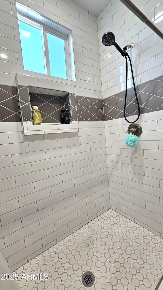 bathroom with tiled shower