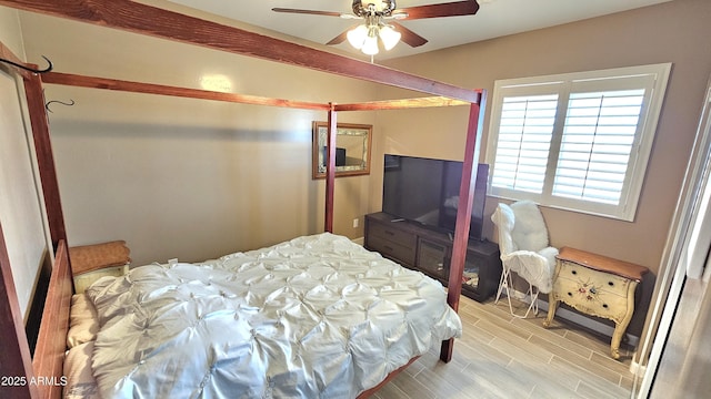 bedroom featuring ceiling fan and wood tiled floor