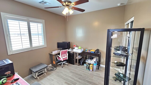 office with visible vents, baseboards, and ceiling fan