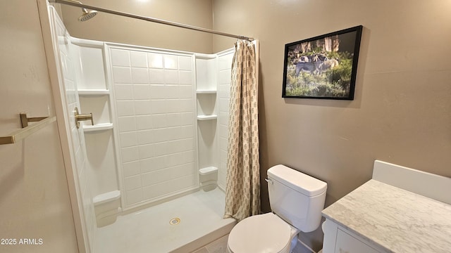 full bath featuring vanity, toilet, and a shower stall