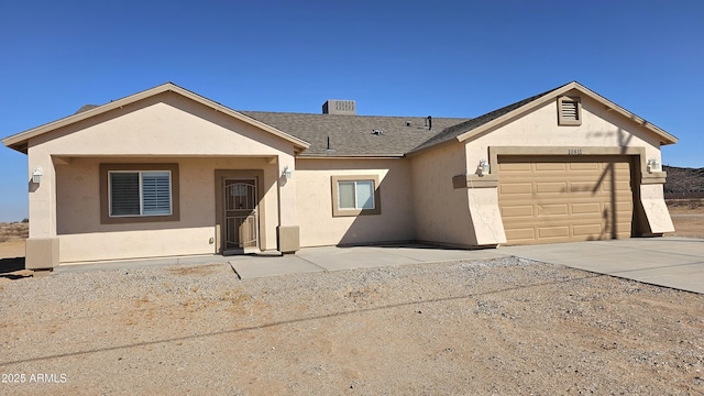 ranch-style house with stucco siding, an attached garage, concrete driveway, and roof with shingles