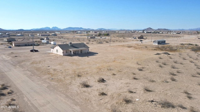 drone / aerial view featuring a mountain view, a rural view, and view of desert