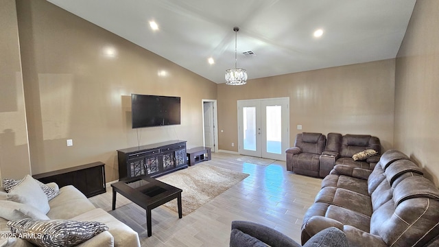 living room featuring light wood-type flooring, visible vents, high vaulted ceiling, french doors, and a chandelier