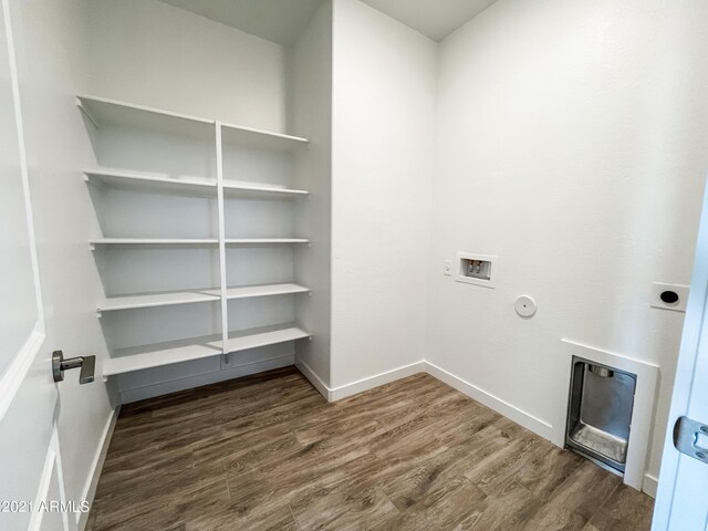 clothes washing area featuring hookup for a washing machine, wood finished floors, baseboards, and gas dryer hookup