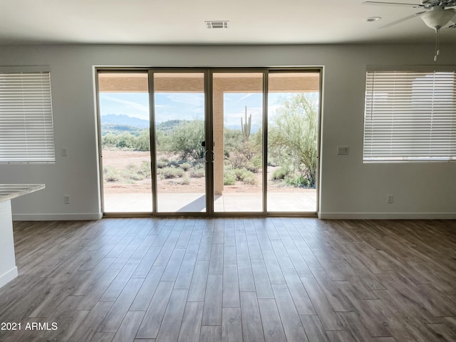 entryway featuring visible vents, plenty of natural light, baseboards, and wood finished floors