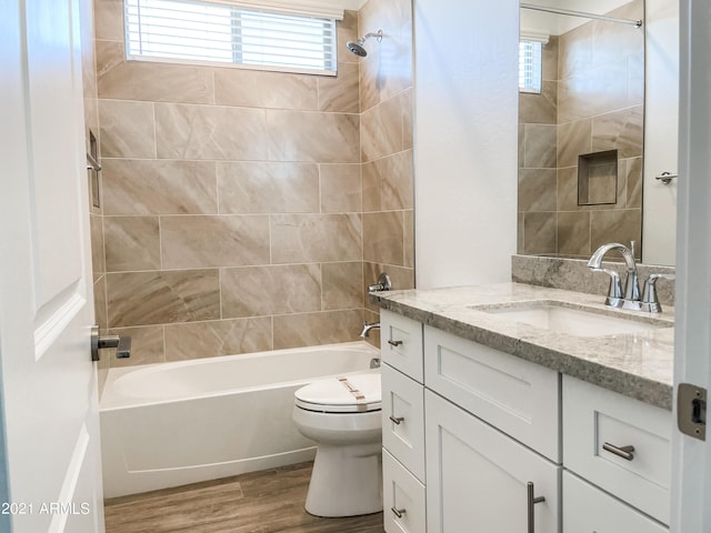 full bath featuring toilet, vanity, shower / bathtub combination, and wood finished floors