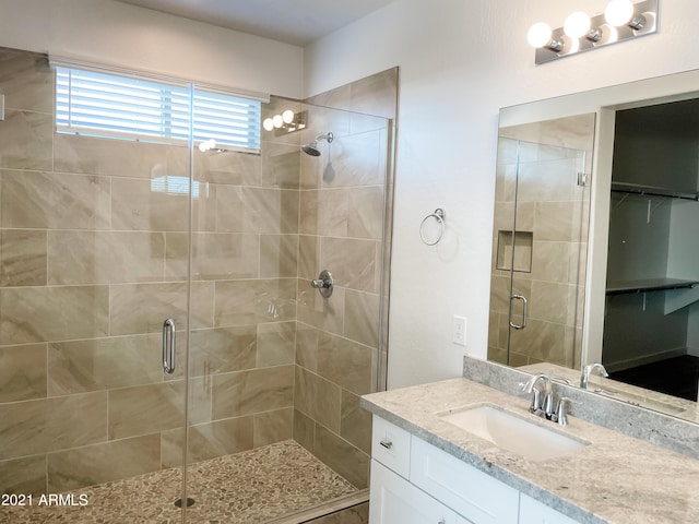 bathroom with vanity and a shower stall