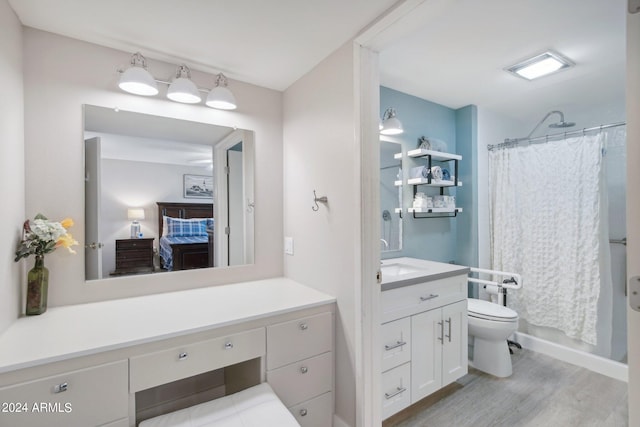 full bathroom with shower / tub combo, hardwood / wood-style flooring, toilet, and vanity