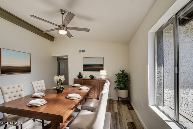 dining area with dark hardwood / wood-style flooring, vaulted ceiling, and ceiling fan