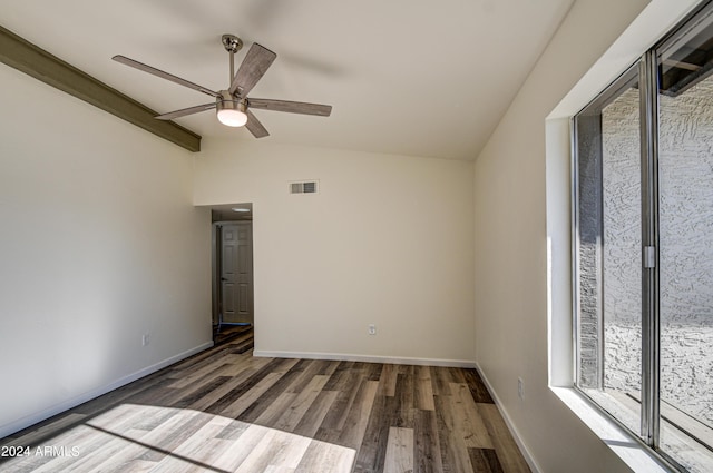 empty room featuring ceiling fan, lofted ceiling, and dark hardwood / wood-style flooring