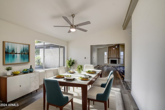 dining area featuring lofted ceiling, dark hardwood / wood-style floors, and ceiling fan