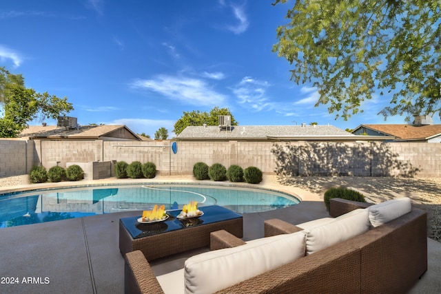 view of pool featuring an outdoor living space with a fire pit and central AC unit