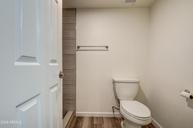 bathroom featuring hardwood / wood-style flooring and toilet